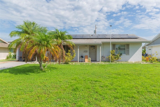 exterior space with a front lawn and solar panels