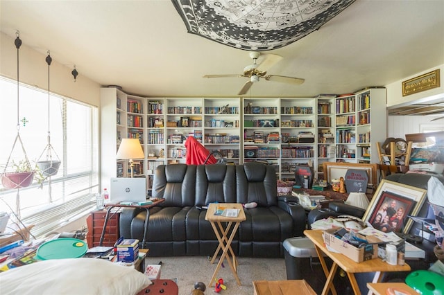 carpeted living room with ceiling fan