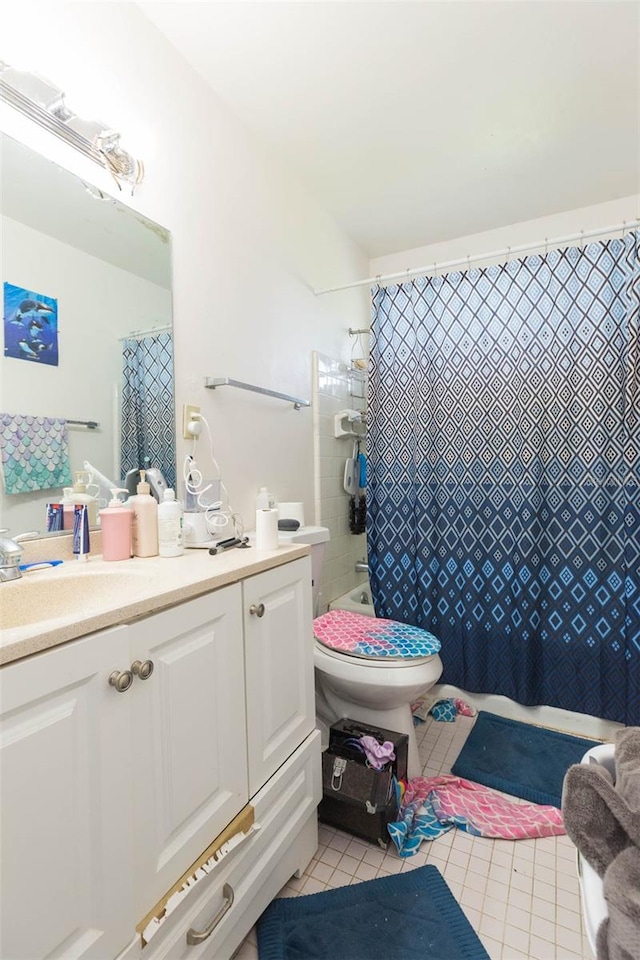 full bathroom featuring toilet, tile patterned flooring, shower / tub combo with curtain, and vanity