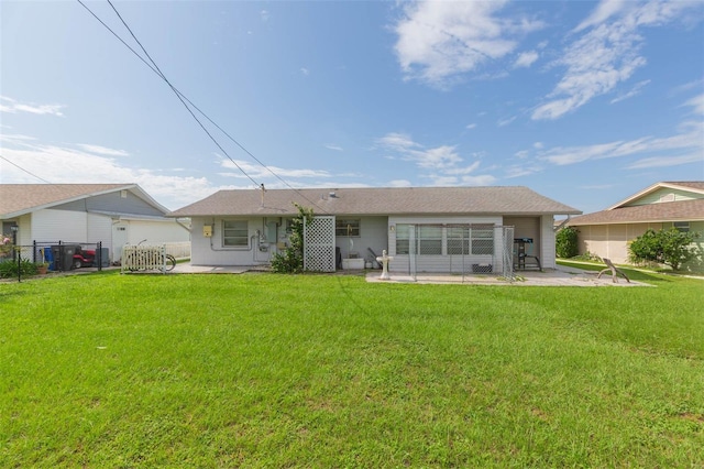 rear view of property featuring a patio area and a yard