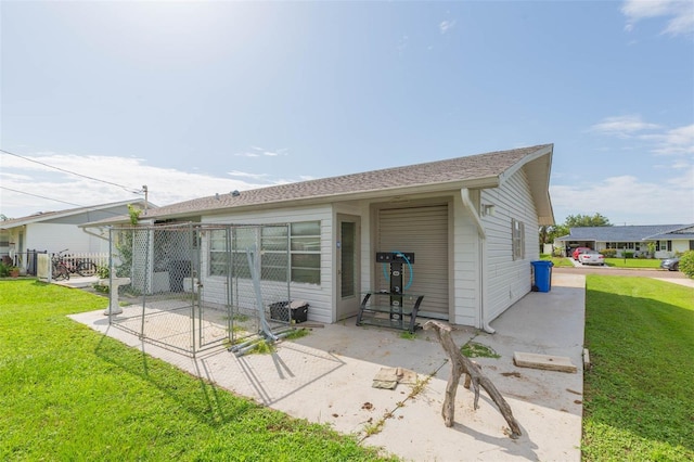 rear view of property featuring a lawn