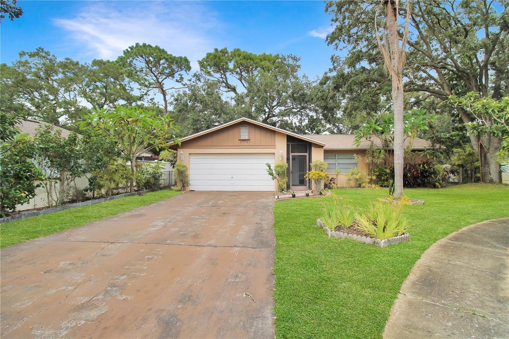 ranch-style home with a garage and a front lawn