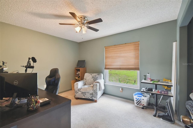 carpeted office space with ceiling fan and a textured ceiling