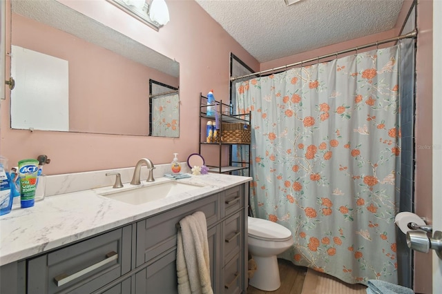 bathroom featuring walk in shower, a textured ceiling, toilet, vanity, and hardwood / wood-style flooring