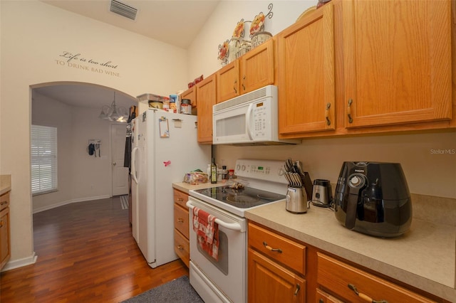 kitchen with white appliances and dark wood-type flooring