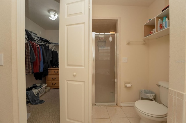 bathroom featuring tile patterned flooring, an enclosed shower, and toilet