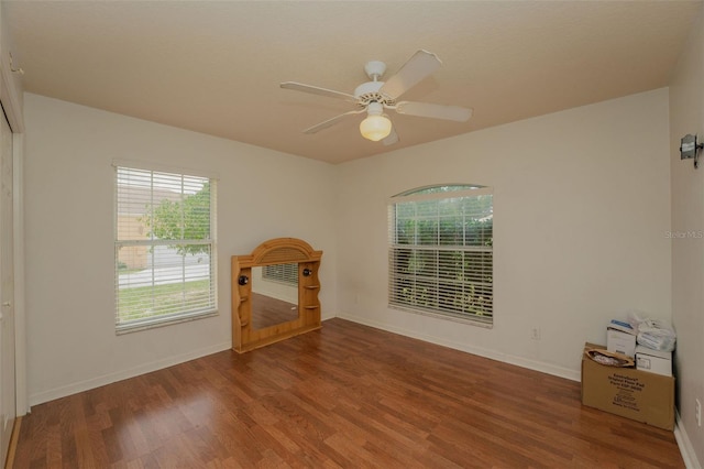 unfurnished living room with ceiling fan and hardwood / wood-style flooring