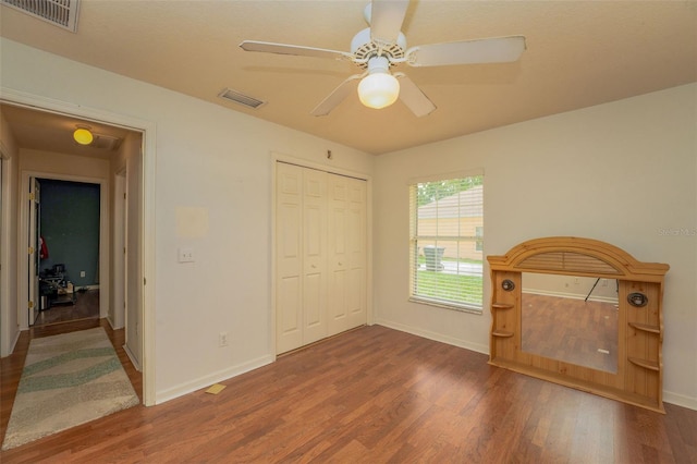 unfurnished bedroom featuring a closet, ceiling fan, and hardwood / wood-style floors