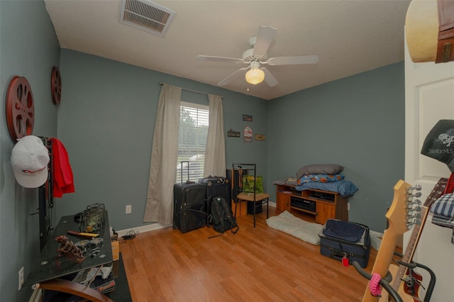 misc room with ceiling fan and light hardwood / wood-style floors