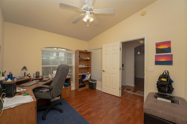 home office featuring ceiling fan, dark hardwood / wood-style floors, and vaulted ceiling