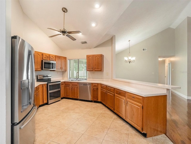 kitchen with appliances with stainless steel finishes, light hardwood / wood-style flooring, high vaulted ceiling, ceiling fan with notable chandelier, and kitchen peninsula