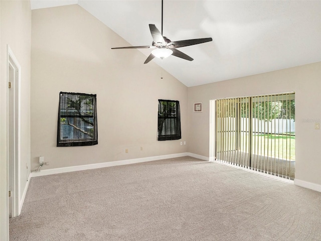 carpeted empty room featuring ceiling fan and high vaulted ceiling