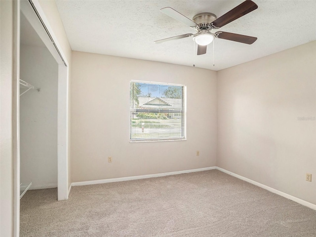 unfurnished bedroom featuring ceiling fan, a textured ceiling, and carpet flooring