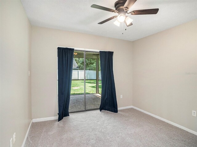 spare room featuring ceiling fan, carpet flooring, and a textured ceiling