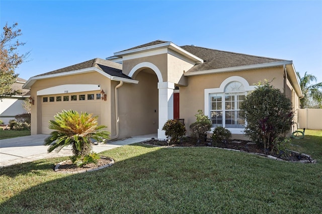 7720 Rathdown Ln, Wesley Chapel, FL 33545 - view of front of house featuring an attached garage, stucco siding, a front lawn, driveway, and a shingled roof