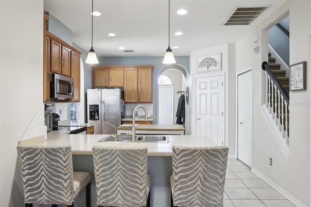 7720 Rathdown Ln, Wesley Chapel, FL 33545 - kitchen with stainless steel appliances, light countertops, a peninsula, recessed lighting, and decorative light fixtures