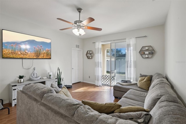 living room featuring ceiling fan and light hardwood / wood-style floors