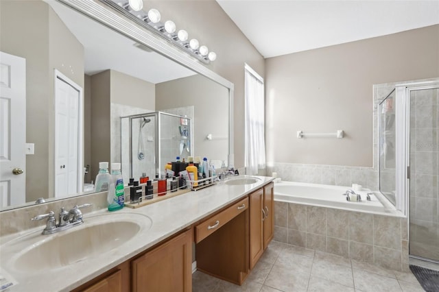 7720 Rathdown Ln, Wesley Chapel, FL 33545 - bathroom featuring double vanity, a stall shower, tile patterned flooring, and a bath