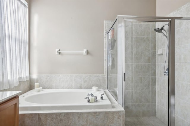 bathroom featuring shower with separate bathtub and vanity