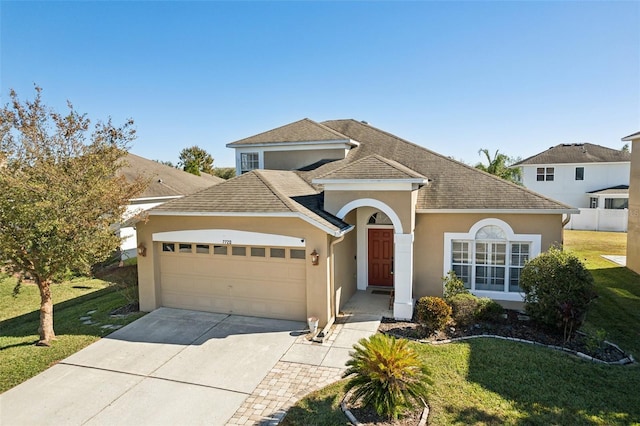 7720 Rathdown Ln, Wesley Chapel, FL 33545 - view of front of house featuring a garage, stucco siding, a front lawn, driveway, and a shingled roof