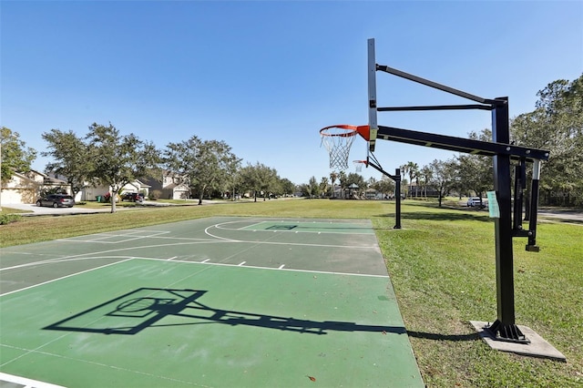 view of basketball court with a lawn