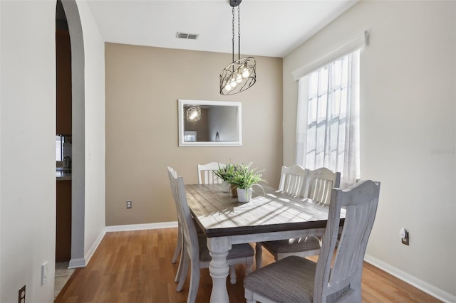 dining room featuring light hardwood / wood-style floors and an inviting chandelier