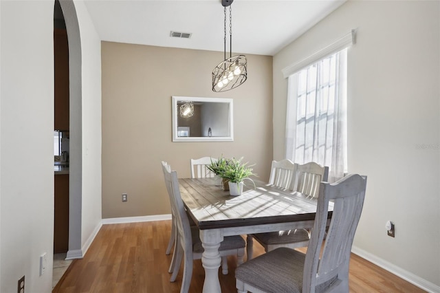 7720 Rathdown Ln, Wesley Chapel, FL 33545 - dining room with arched walkways and light wood finished floors