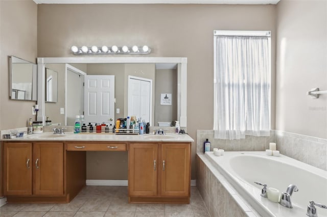 bathroom featuring tile patterned floors, tiled bath, and vanity