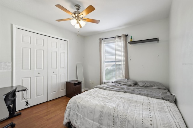 bedroom with ceiling fan, a closet, and wood-type flooring