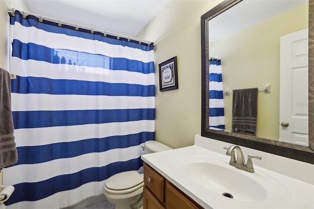 bathroom with vanity, toilet, and curtained shower