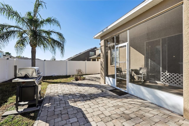7720 Rathdown Ln, Wesley Chapel, FL 33545 - fenced backyard with a patio, a sunroom, and grilling area