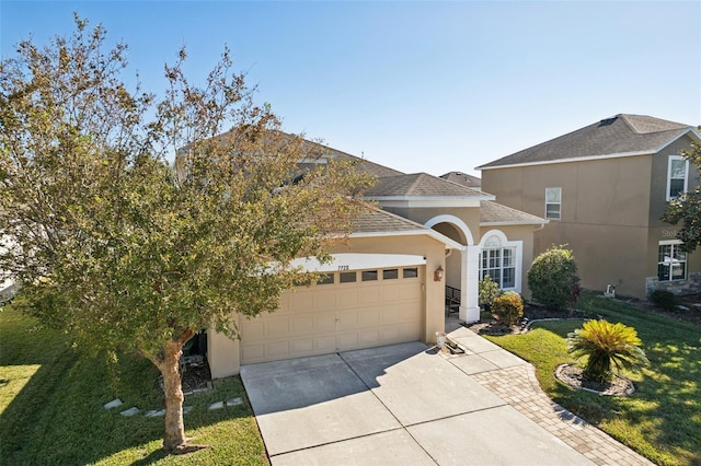 7720 Rathdown Ln, Wesley Chapel, FL 33545 - view of front of home featuring concrete driveway, an attached garage, stucco siding, a front yard, and roof with shingles