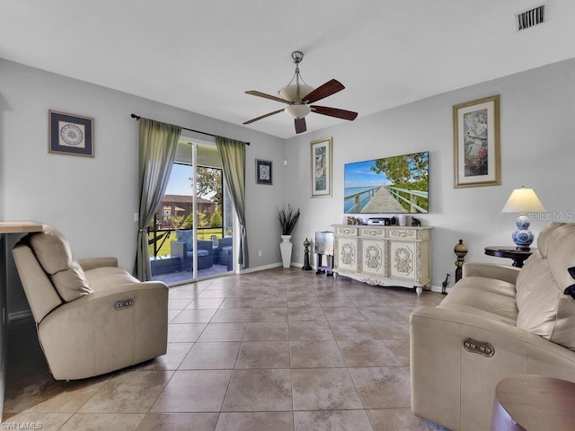 living room featuring ceiling fan and tile patterned floors