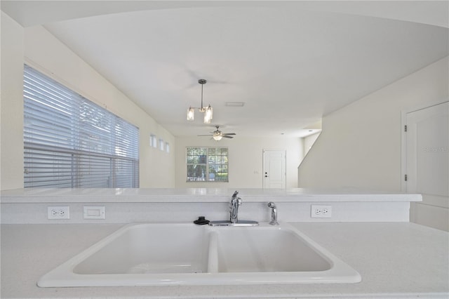 kitchen featuring hanging light fixtures, sink, and ceiling fan