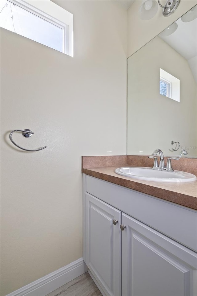 bathroom featuring vanity, plenty of natural light, and hardwood / wood-style flooring