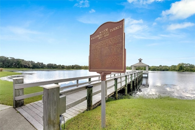 dock area featuring a water view and a yard