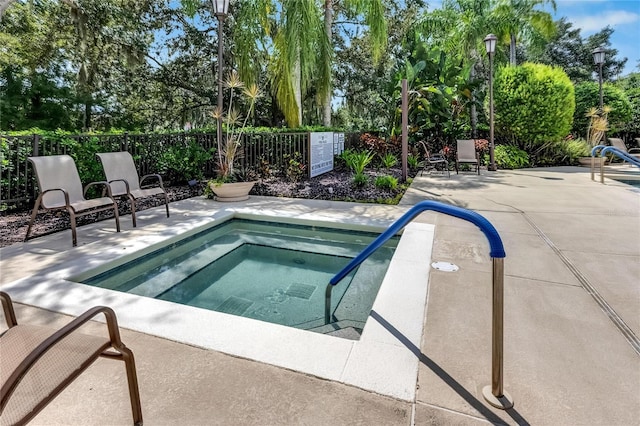 view of swimming pool with a community hot tub and a patio