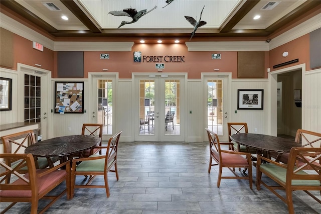 dining area with a towering ceiling, beamed ceiling, french doors, and crown molding