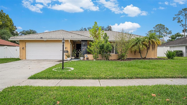 single story home featuring a garage and a front yard