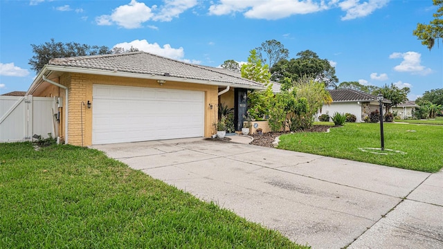 view of front of house with a garage and a front lawn