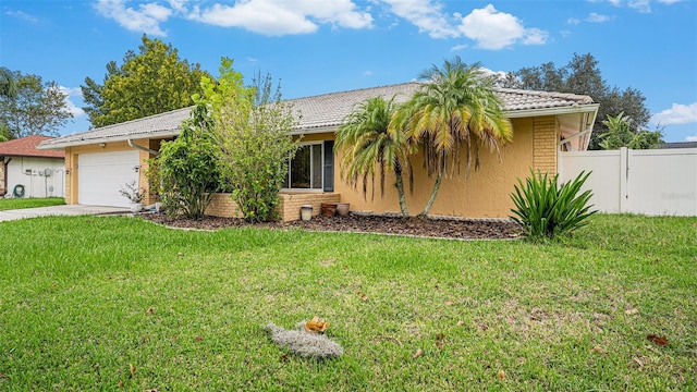 view of front of property with a garage and a front lawn