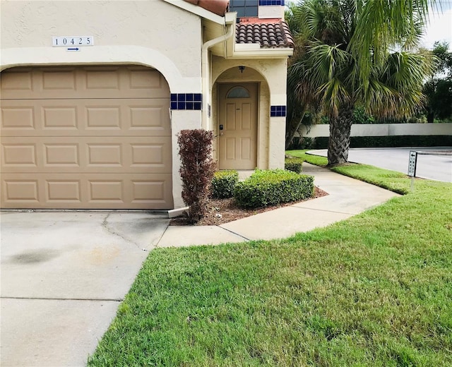 exterior space with a garage and a lawn