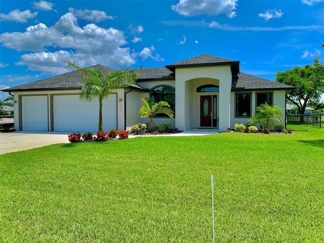 view of front facade with a garage and a front yard