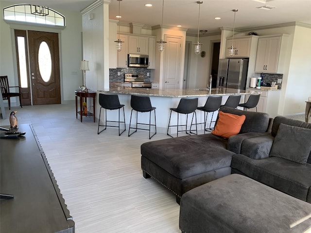 living room featuring sink and ornamental molding