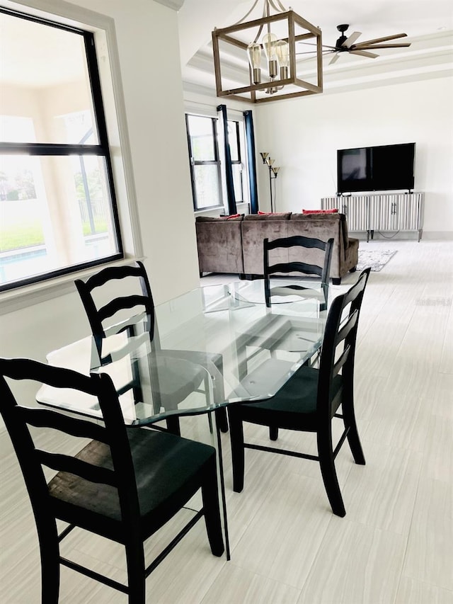 dining space featuring plenty of natural light and ceiling fan with notable chandelier