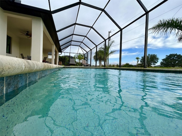 view of pool featuring glass enclosure