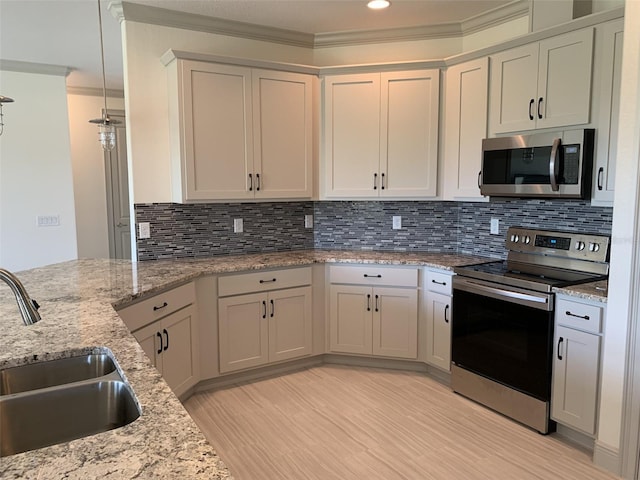 kitchen featuring light stone countertops, appliances with stainless steel finishes, backsplash, ornamental molding, and sink