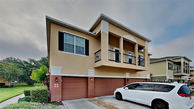 view of front of home with a balcony and a garage