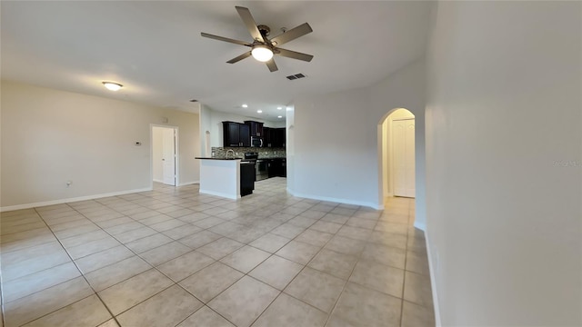 unfurnished living room featuring ceiling fan and light tile patterned floors