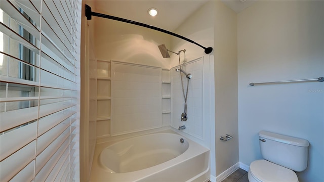 bathroom featuring shower / bathtub combination, toilet, and tile patterned floors